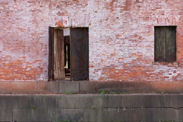 old rusty window and door on old brick wall