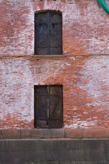 Fototapeta na wymiar old rusty door on old brick wall background