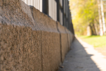 abstract background with strong blur track along cast iron fence on granite stand