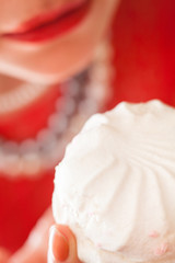 Woman eating marshmallow.