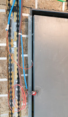 insulation and electrical wiring around an elevator shaft on a construction site