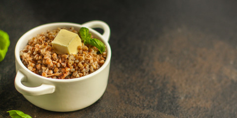 buckwheat porridge and a piece of butter (delicious food) homemade dish. food background. top