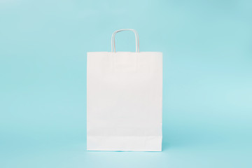 White paper bag on blue background. Mock up