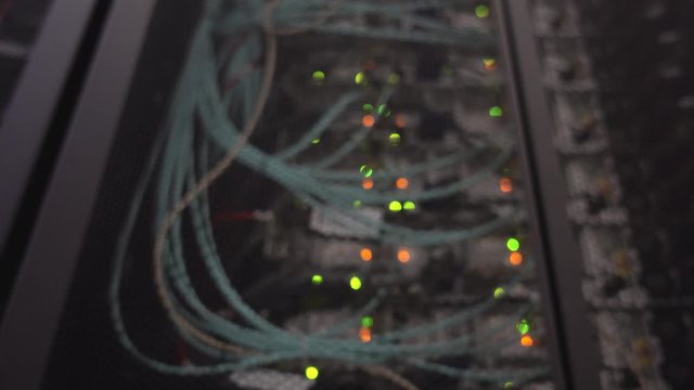 Data center, server room in a blurry background. Blinking blue and orange led ligts