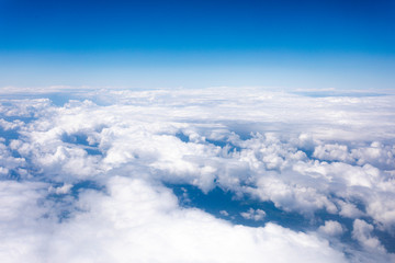 Fototapeta na wymiar Earth in the airplane window with clouds