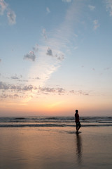 Silhouette of youth walking at Juhu beach