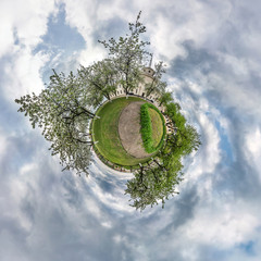 Little planet spherical panorama 360 degrees. Spherical aerial view  in blooming apple garden...