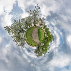 Little planet spherical panorama 360 degrees. Spherical aerial view  in blooming apple garden...