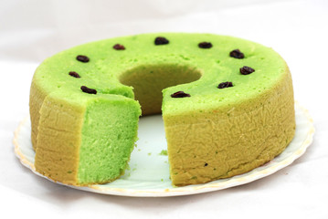 Green tea flavored sponge bread light green with raisin seeds above it
