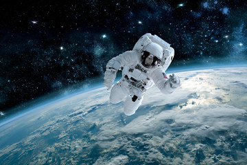 Photo of astronaut in space, in background planet earth. Elements of this image furnished by NASA.