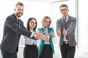 professional employees of the company showing thumbs up.