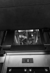 Young family walking inside the modern building in high-tech architecture style. Happy christian...