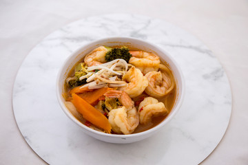 Tom Yam kung Spicy Thai soup in bowl