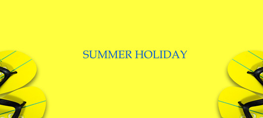 Concept of a summer holiday. Beach slippers on a bright yellow background. Copy space. Top View. Place for text. Easy to clean text. Summer holiday banner.