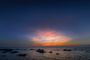 Fototapeta na wymiar The rock on the sea with sunset sky