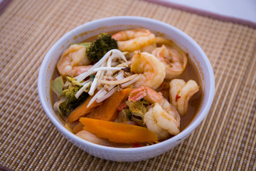 Tom Yam kung Spicy Thai soup in bowl