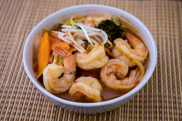 Tom Yam kung Spicy Thai soup in bowl