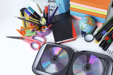 stack of CDs and school supplies isolated on white background.photo with copy space