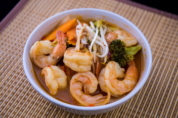 Tom Yam kung Spicy Thai soup in bowl