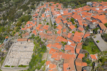 Aerial view of small rural village with red roofs located in mountains. Top View of Monsanto...