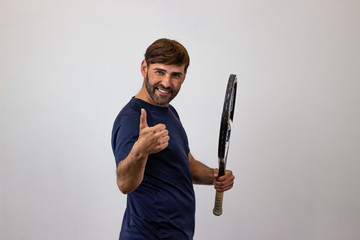 Portrait of handsome young man playing tennis holding a racket with brown hair clapping hands, their back facing the camera and looking at the camera. Isolated on white background.