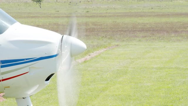 Small aircraft ready to fly on track in a small civil airdrome.