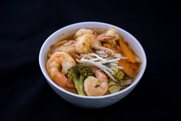 Tom Yam kung Spicy Thai soup in bowl