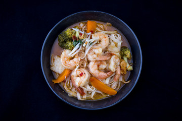 Tom Yam kung Spicy Thai soup in bowl