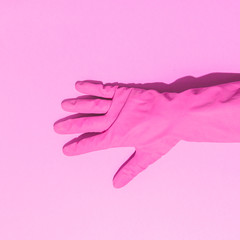 Fashion creative concept with hand in pink rubber glove, showing gesture.  Aesthetic abstract minimalism. Flat lay