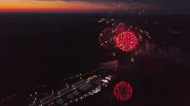 aerial late sunset firewok holiday fest reflection in the water evening night river