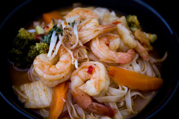 Tom Yam kung Spicy Thai soup in bowl