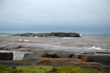 The strong waves of the White Sea crashing on the rocky shore