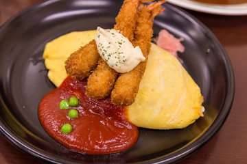 Japanese style fried rice omelet (Omurice) with deep fried shrimp.