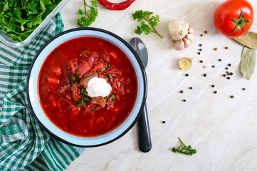 Borsch is a traditional Ukrainian dish in a bowl on the table. Tasty and healthy lunch. Top view, flat lay.
