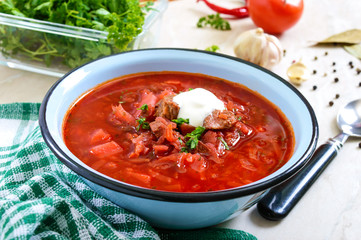 Borsch is a traditional Ukrainian dish in a bowl on the table. Tasty and healthy lunch.