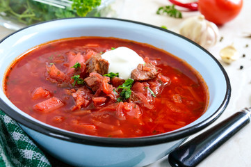 Borsch is a traditional Ukrainian dish in a bowl on the table. Tasty and healthy lunch.