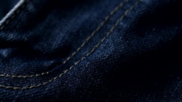 Blue denim jeans close up 4K stock footage. Blue denim Jeans in close up with a sliding camera move.