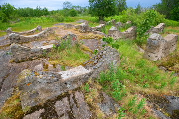 Fototapeta na wymiar Old foundation of the destroyed building on the stone coast of the White Sea in the vicinity of the village Rabocheostrovsk, Popov Island, Kemsky District, Republic of Karelia, Russia