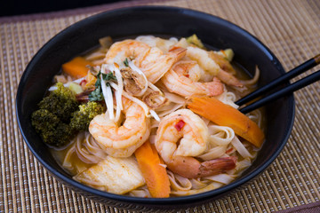 Tom Yam kung Spicy Thai soup in bowl