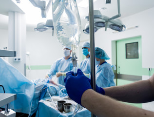 Arthroscope surgery. Orthopedic surgeons in teamwork in the operating room with modern arthroscopic...