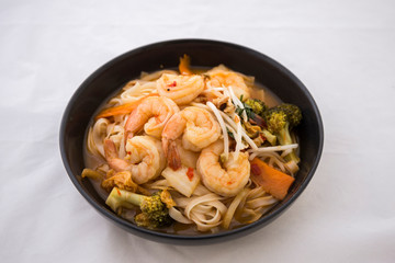Tom Yam kung Spicy Thai soup in bowl