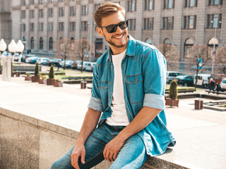 Portrait of handsome smiling stylish hipster lumbersexual businessman model. Man dressed in jeans...
