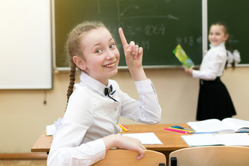 Girl schoolgirl rejoices that he knows the correct answer to the question. Invented a brilliant...