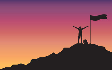 Silhouette happy man raising hand standing on top of mountain