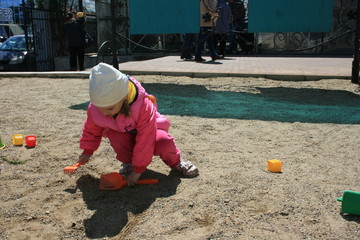 A little girl spends time in the city Park.