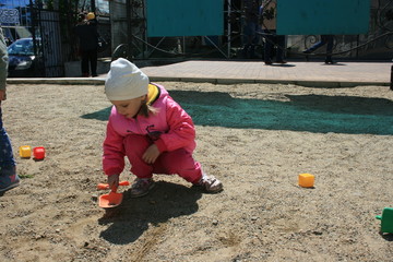 A little girl spends time in the city Park.