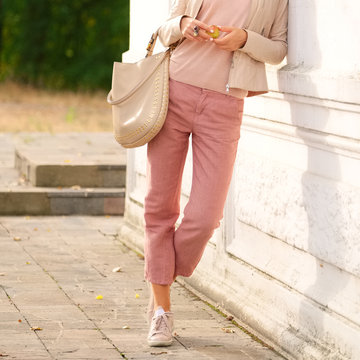 Female legs in linen trousers. Spring-aunumt outfit.