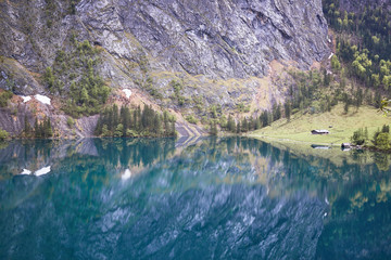German lodge reflecting in lake obersee