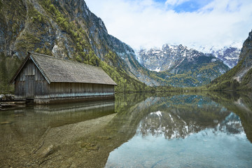 Fototapeta na wymiar boathouse reflecting in obersee germany