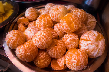Heap of fresh ripe peeled oranges or tangerines in a bowl - Image